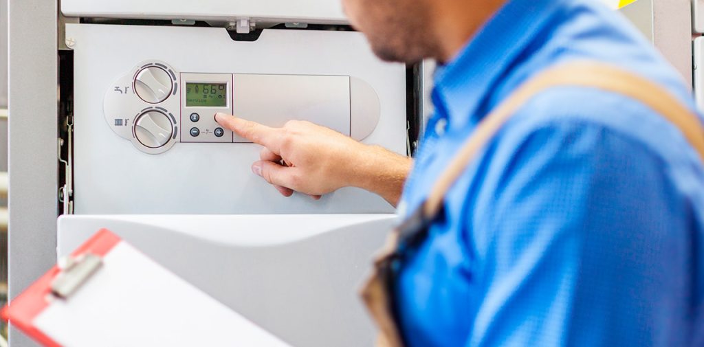 Boilerable engineer inspecting and adjusting a modern boiler for reliable heating services in Warrington.